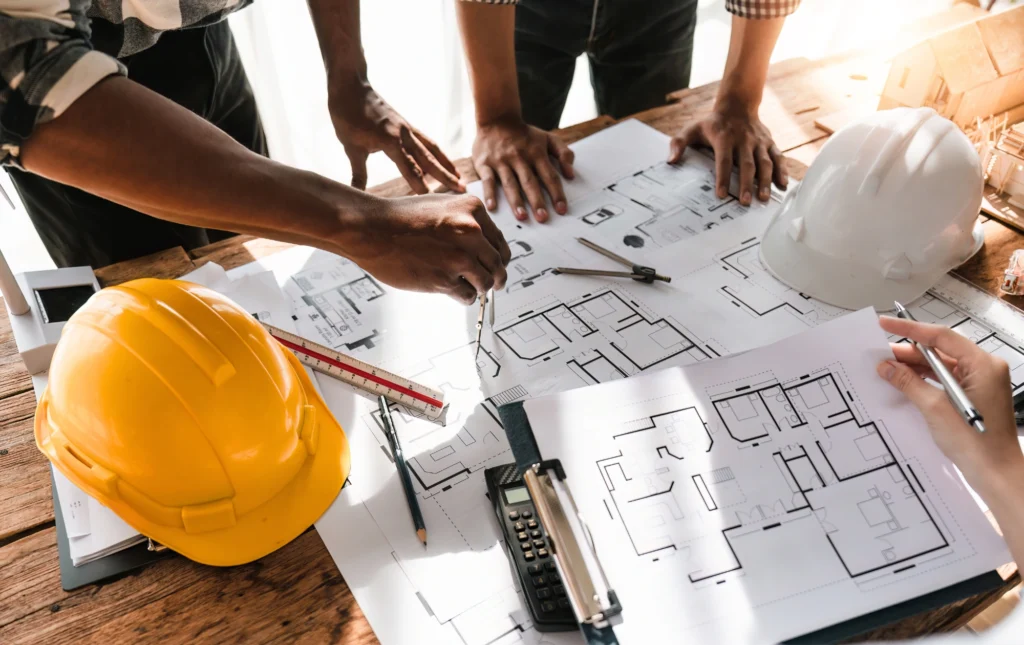 Collaboration entre professionnels et communauté rurale pour un projet de construction.