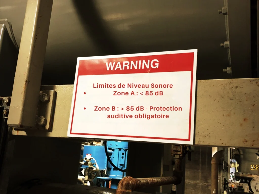 Tableau des limites sonores et protections auditives dans une usine illustrant les normes acoustiques.